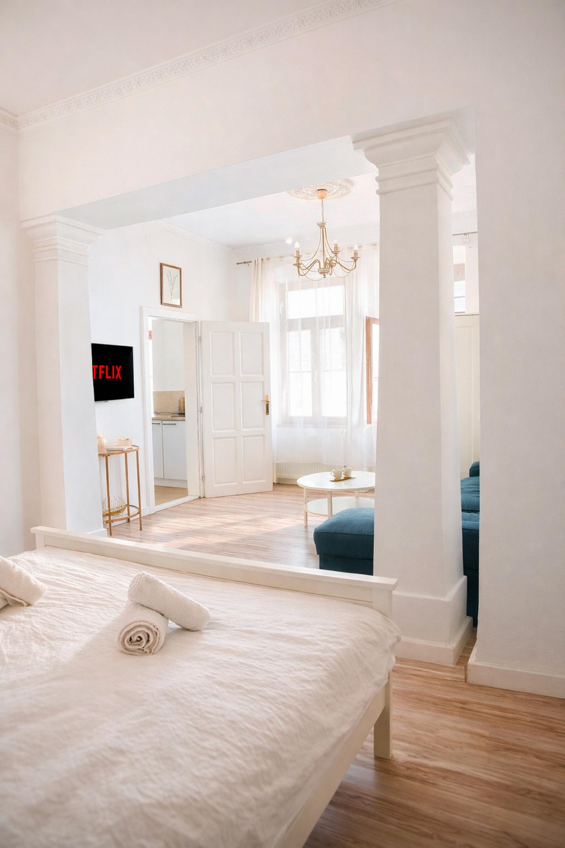 Soft bedroom scene with light and view through the apartment