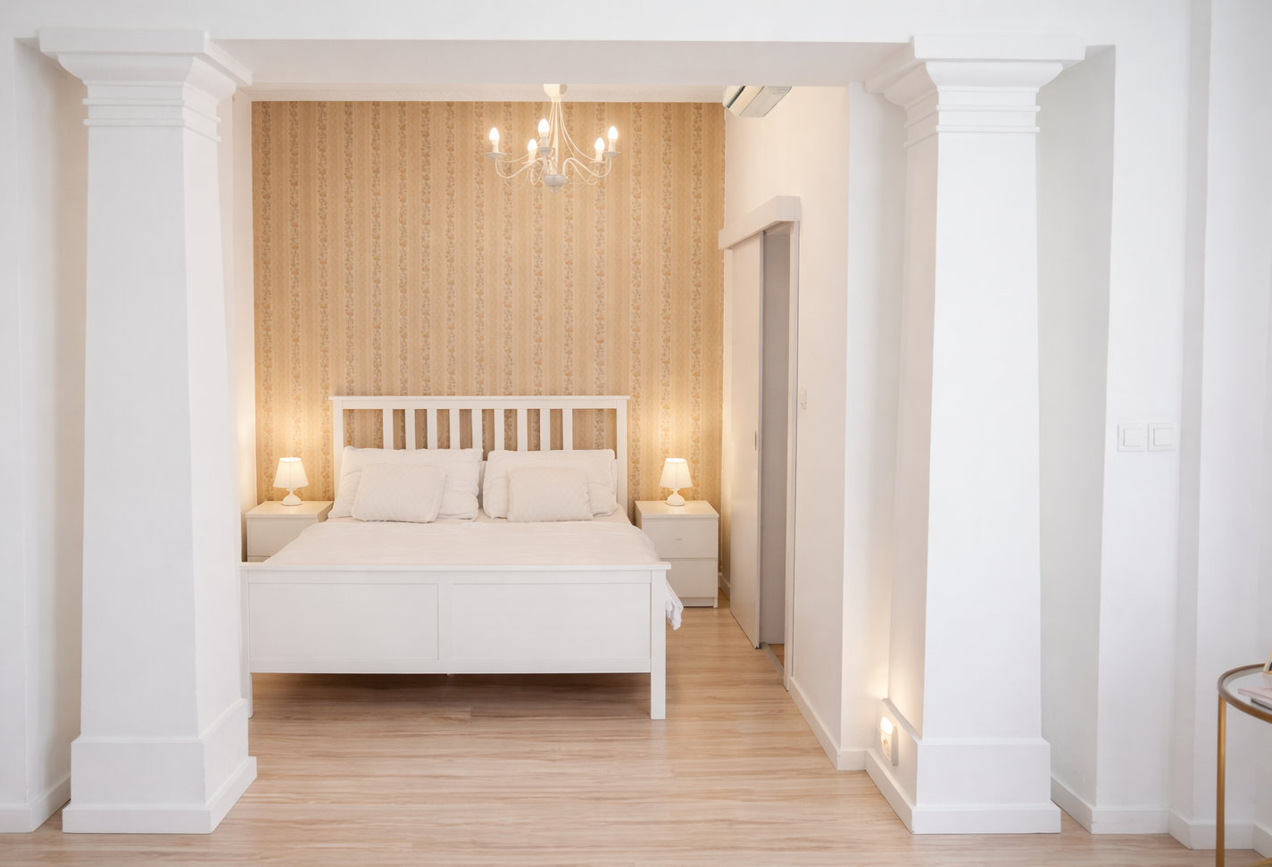 Bright bedroom framed by the signature columns